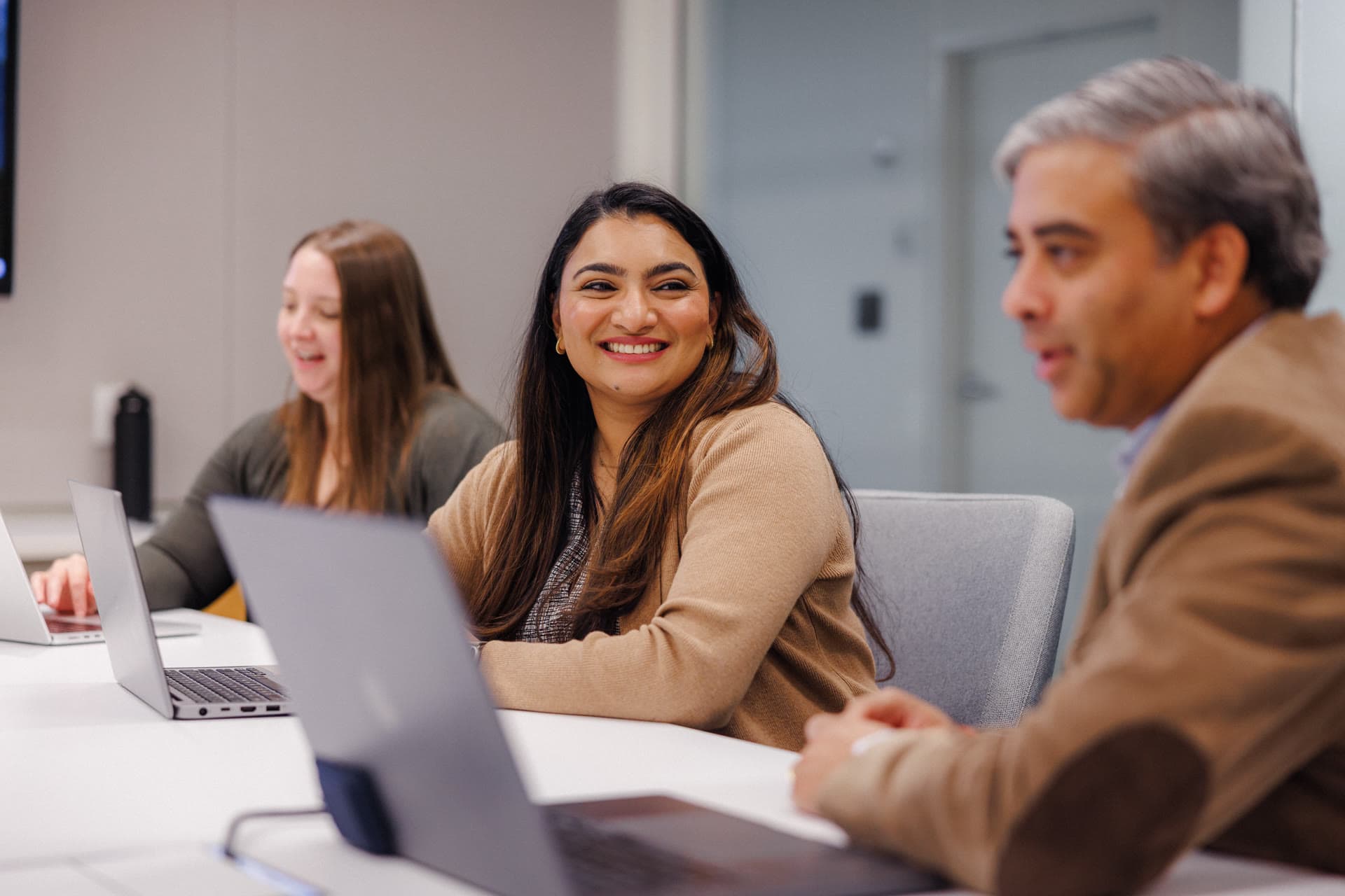 Team members meeting around a conference table